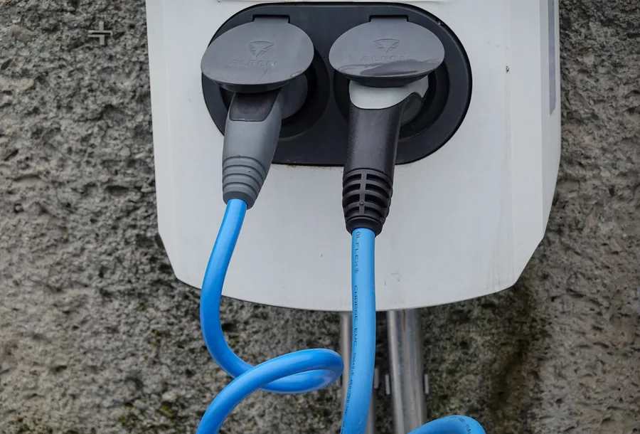 Charging cables connected to a wall-mounted electric car charger