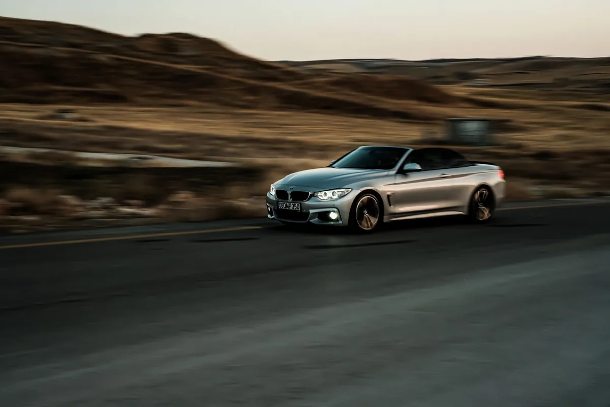 A car driving quickly on an open road