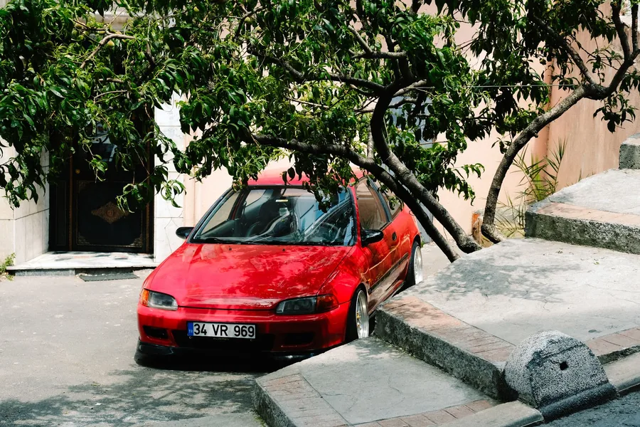 A small hatchback parked at the kerb on a city street