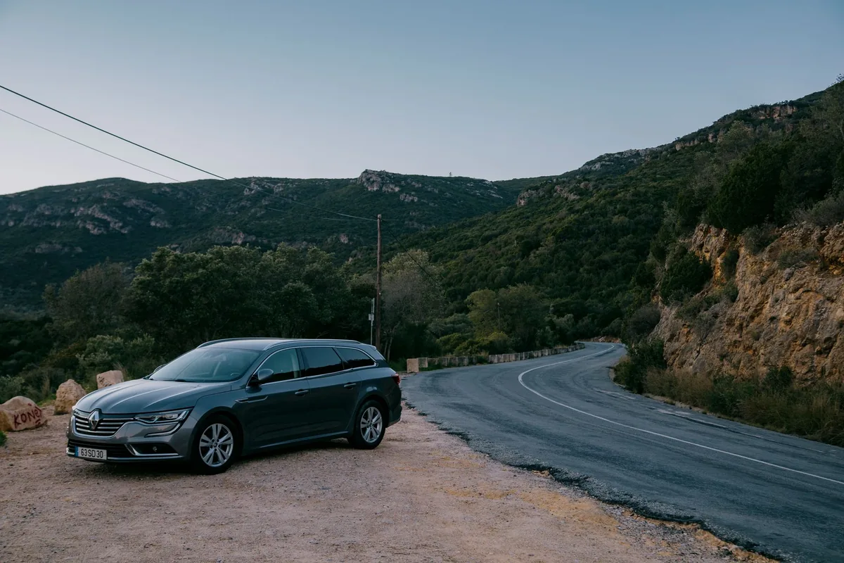 A car driving on a winding country road in France