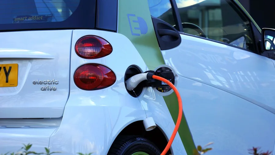 An electric car's charging port with a cable plugged in
