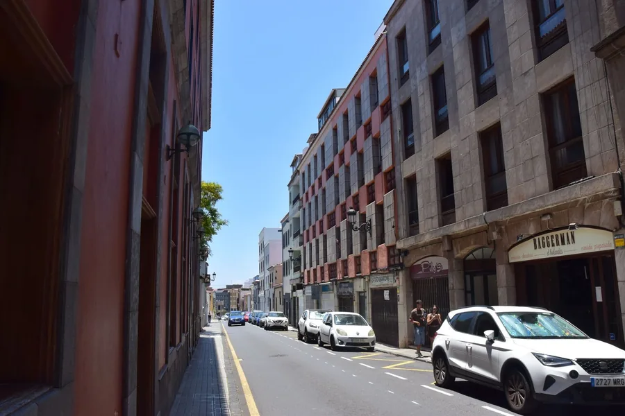 A white car parked on a narrow Spanish street