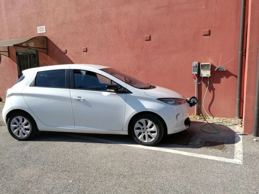 An electric car plugged into a charging point