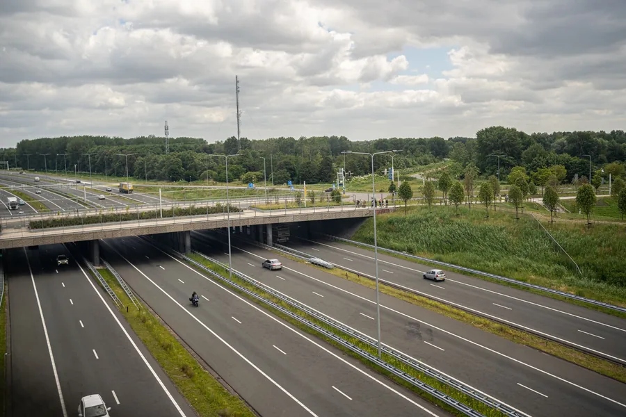 Aerial view of a busy Dutch motorway with cars and lorries on the carriageways