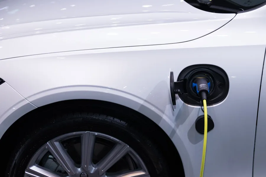 Close-up of a charging cable plugged into an electric car's charging port