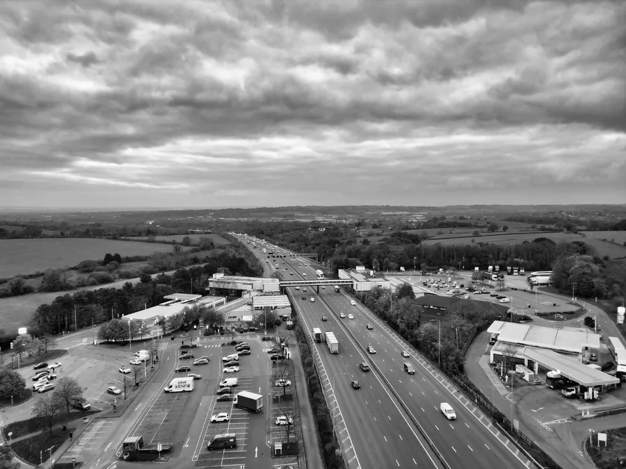 Aerial monochrome view of a busy motorway crossing open countryside
