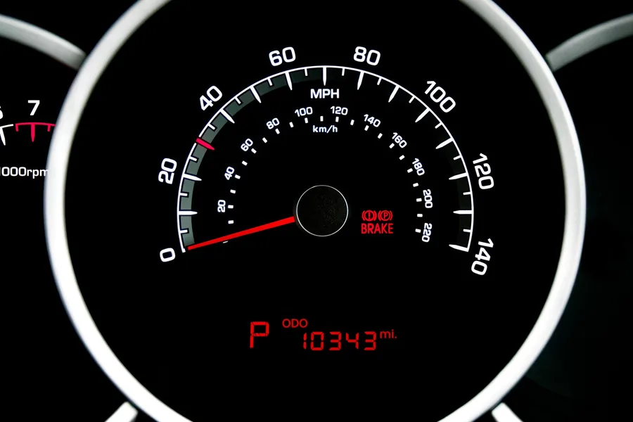 A car instrument cluster showing speed in miles per hour and an odometer reading
