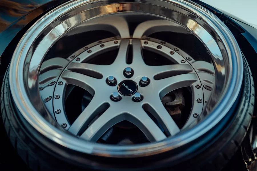 A close-up of an alloy wheel and tyre on a dark car