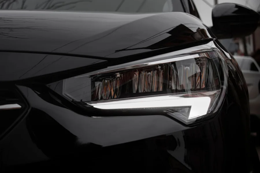Close-up of a modern car headlight and front wing