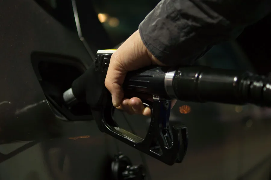 A fuel nozzle being inserted into a car's capless filler neck