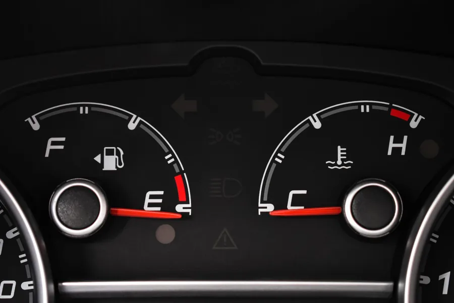 A car instrument cluster with analogue dials and a digital display