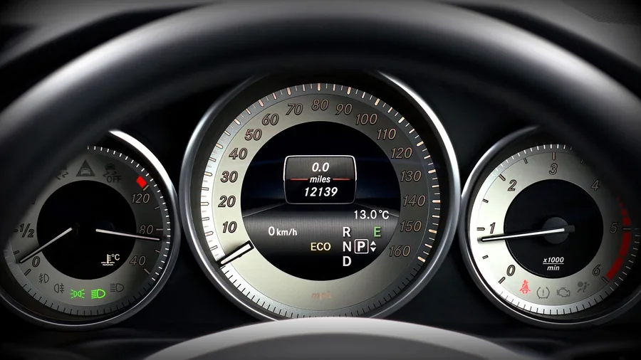 Close-up of a car instrument cluster with speedometer, odometer and fuel gauge