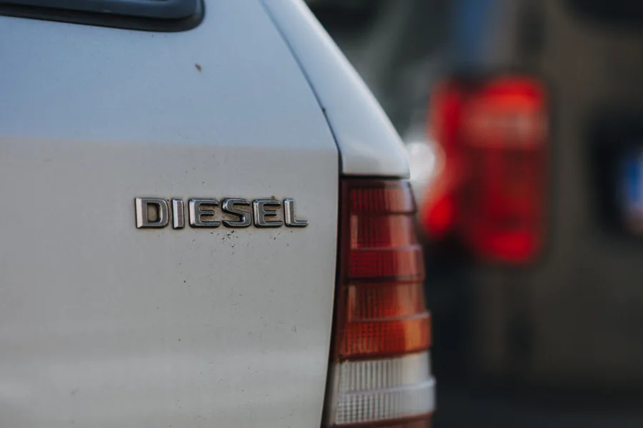 A chrome badge reading DIESEL on the rear panel of a white car